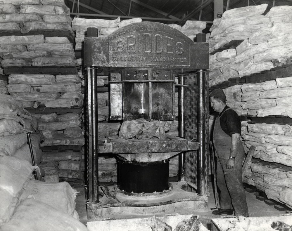 Dunlop raw materials; rubber bales being cut into smaller pieces