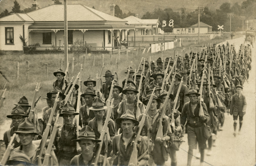 Soldiers marching down street 