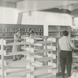 Library 2, 6 Main Street; assembling transferred shelving, 1956